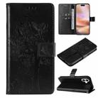 For iPhone 16 Plus Tree & Cat Embossed Pattern Flip Leather Phone Case(Black) - 1