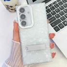 For Samsung Galaxy S24 5G Plating Glitter Texture Fold Holder TPU Phone Case with Lens Film(White Shell Pattern) - 1