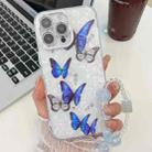 For iPhone 15 Pro Plating Texture Butterfly Wristband TPU Phone Case with Glitter Lens Film(Blue Butterflies HU3) - 1
