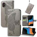 For Samsung Galaxy Xcover6 Pro Butterfly Love Flower Embossed Flip Leather Phone Case(Gray)